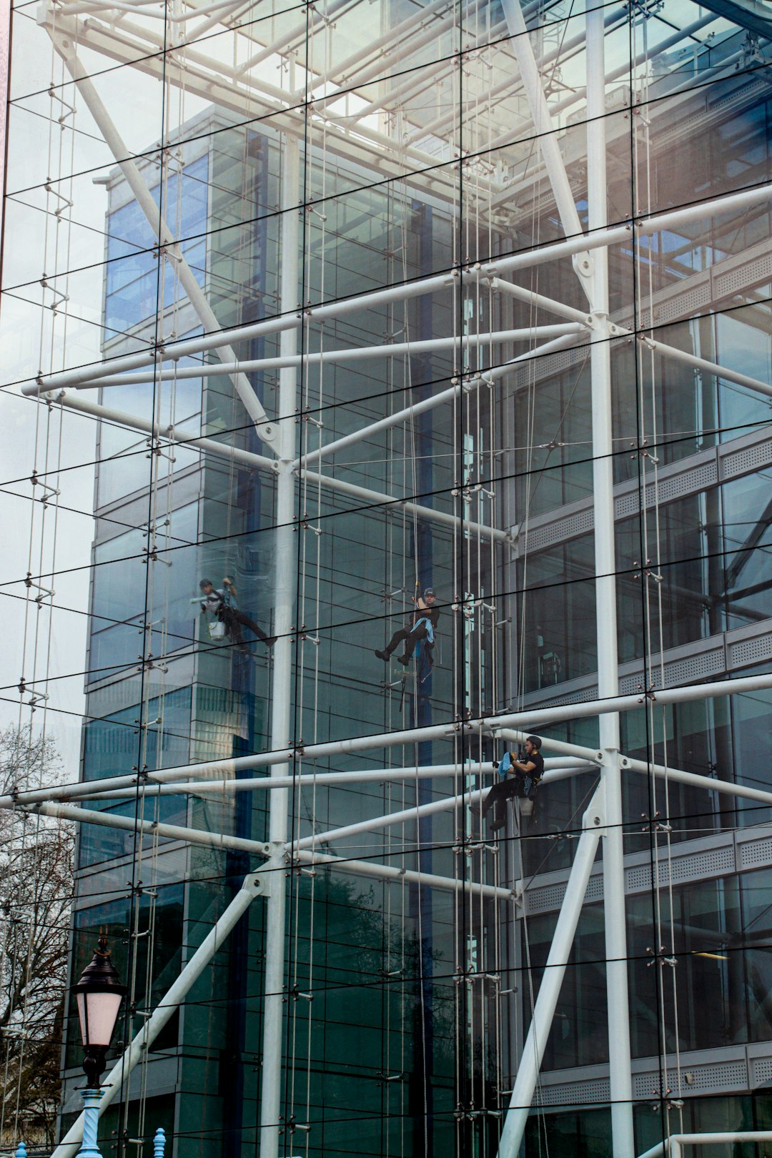 our-story Window cleaners working from ropes on the inside of a Tower Bridge House London