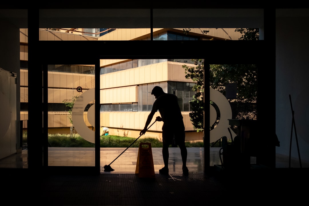 gallery-04 Man cleans floor at an entrance door.